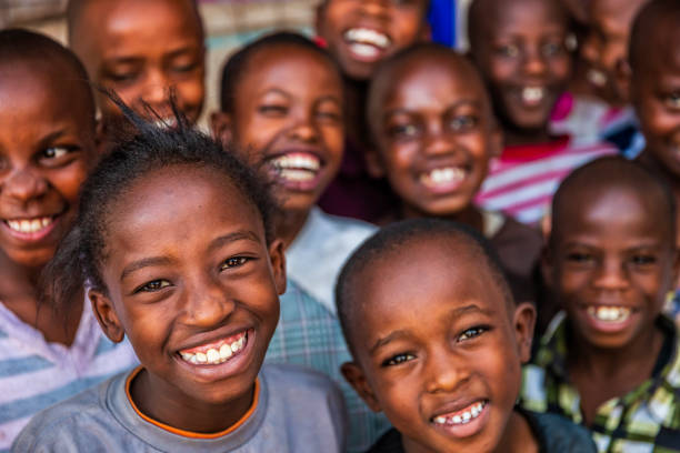 group of happy african children living in an orphanage in kenya, east africa